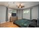 Bedroom with two windows, ceiling fan, and a wood dresser with a TV at 10839 Carrol Ln, Northglenn, CO 80233