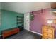 Unique bedroom with colorful walls, wood dresser, and quirky decor at 10839 Carrol Ln, Northglenn, CO 80233