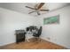 Bright bedroom with hardwood floors, one window, a gaming chair and equipment, and a ceiling fan at 10839 Carrol Ln, Northglenn, CO 80233