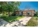 Charming brick ranch home with a well-maintained front yard and long driveway at 10839 Carrol Ln, Northglenn, CO 80233