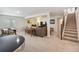 Finished basement with neutral carpet, a sitting area, a small dining table, and stairs to the upper level at 16840 New Autumn Dr, Monument, CO 80132