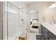 Bright bathroom features a glass shower, a single vanity, and tile flooring and walls at 16840 New Autumn Dr, Monument, CO 80132