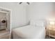 Inviting bedroom featuring a queen bed, side table and doorway to the laundry room at 16840 New Autumn Dr, Monument, CO 80132