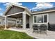 Relaxing covered patio with dining area and grill; ideal for outdoor entertaining at 16840 New Autumn Dr, Monument, CO 80132