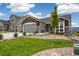Charming gray home with a three car garage and beautifully xeriscaped front yard at 16840 New Autumn Dr, Monument, CO 80132