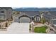 Charming gray home with a three car garage and beautifully xeriscaped front yard at 16840 New Autumn Dr, Monument, CO 80132