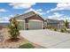 Charming home featuring a two-car garage, stone accents, and a well-maintained lawn at 16840 New Autumn Dr, Monument, CO 80132