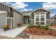 Home featuring stone accents, a cozy front porch, and a well-maintained landscape at 16840 New Autumn Dr, Monument, CO 80132