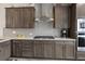 Modern kitchen with gray cabinets, stainless steel appliances, light countertops, and gray subway tile backsplash at 16840 New Autumn Dr, Monument, CO 80132
