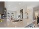 Bright kitchen features an island with granite countertop, stainless steel appliances, and views to the living area at 16840 New Autumn Dr, Monument, CO 80132