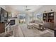 Bright living room with a stone fireplace, plush seating, and expansive windows overlooking the community at 16840 New Autumn Dr, Monument, CO 80132