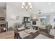 Open floor plan with a fireplace, dining table, and living room with lots of natural light at 16840 New Autumn Dr, Monument, CO 80132