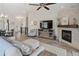 Cozy living room with hardwood floors, a fireplace, and open access to the kitchen and dining area at 16840 New Autumn Dr, Monument, CO 80132