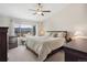 Carpeted main bedroom with a ceiling fan, two dressers, a queen bed, and a window with a mountain view at 16840 New Autumn Dr, Monument, CO 80132