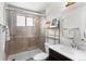 Bathroom featuring walk-in shower with glass door, vanity, and neutral color scheme at 558 N Washington St # 305, Denver, CO 80203