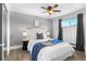 Comfortable bedroom with a decorative tray, ceiling fan, and large window that provides natural light at 558 N Washington St # 305, Denver, CO 80203