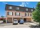 Exterior view of a well-maintained brick building with parking and street-front retail at 558 N Washington St # 305, Denver, CO 80203