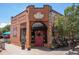 Charming coffee shop exterior with bright signage, outdoor seating, and inviting storefront at 558 N Washington St # 305, Denver, CO 80203