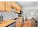 Updated kitchen with butcher block countertops, a stainless steel sink, and hardwood floors throughout the space at 558 N Washington St # 305, Denver, CO 80203