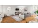 Bright living room showcasing hardwood floors, updated decor, and a comfortable seating area at 558 N Washington St # 305, Denver, CO 80203