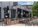 Outdoor patio featuring metal railings, black tables and chairs at Logan Street Restaurant & Bar at 558 N Washington St # 305, Denver, CO 80203