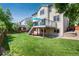 Expansive backyard showcasing a deck, mature trees, and a well-kept lawn at 9610 S Dover Way, Littleton, CO 80127