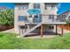View of home's backyard and deck showcasing outdoor living space and a green lawn at 9610 S Dover Way, Littleton, CO 80127