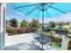 Relax on this lovely deck with elegant railing, flowers, umbrella, and furniture at 9610 S Dover Way, Littleton, CO 80127