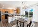 Open dining area and kitchen boasts wood cabinets, granite countertops, and deck access at 9610 S Dover Way, Littleton, CO 80127