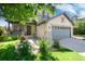 Charming home featuring a well-manicured lawn, beautiful roses, and a two car garage at 9610 S Dover Way, Littleton, CO 80127