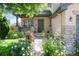 Inviting home with a charming front porch, colorful rose bushes, and a well-kept lawn at 9610 S Dover Way, Littleton, CO 80127