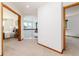 Hallway featuring doors to rooms, and nice carpet at 9610 S Dover Way, Littleton, CO 80127