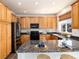 Kitchen featuring wood cabinets, granite countertops, stainless steel appliances and center island at 9610 S Dover Way, Littleton, CO 80127