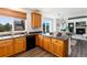 Kitchen features granite countertops, wood cabinets and large windows at 9610 S Dover Way, Littleton, CO 80127