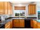 Kitchen featuring beautiful oak cabinets, granite countertops and a large window at 9610 S Dover Way, Littleton, CO 80127