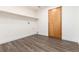 Laundry room with vinyl floors and storage shelves at 9610 S Dover Way, Littleton, CO 80127