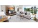 Bright and inviting living room with open-concept design, large windows, and modern furnishings at 9610 S Dover Way, Littleton, CO 80127