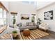 Bright living room with vaulted ceilings, stylish furniture, and ample natural light from the windows at 9610 S Dover Way, Littleton, CO 80127