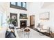 Cozy living room featuring a fireplace, high ceilings, and elegant decor creating a warm atmosphere at 9610 S Dover Way, Littleton, CO 80127