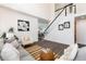 Open-concept living area with stairs and an adjacent dining area, great for entertaining guests at 9610 S Dover Way, Littleton, CO 80127