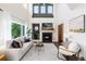Bright and airy living room featuring a fireplace, high ceilings, and elegant decor creating a warm atmosphere at 9610 S Dover Way, Littleton, CO 80127