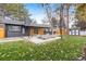 Charming backyard features a patio with seating, mature trees, and well-maintained lawn at 417 S Pontiac Way, Denver, CO 80210