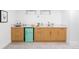 Finished basement bar area with mini-fridge, light wood cabinets and sink at 417 S Pontiac Way, Denver, CO 80210