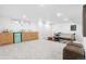Finished basement with carpet, a neutral couch, a mini bar with teal mini fridge at 417 S Pontiac Way, Denver, CO 80210