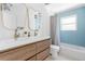 Modern bathroom featuring double sinks, blue tiled shower with glass doors at 417 S Pontiac Way, Denver, CO 80210
