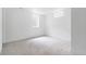 Bright bedroom features white walls, carpet flooring, and windows for natural light at 417 S Pontiac Way, Denver, CO 80210