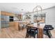 Bright kitchen and dining area with modern cabinets, stainless steel appliances, and a rustic wooden dining table at 417 S Pontiac Way, Denver, CO 80210