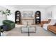 Bright living room featuring hardwood floors, stylish seating, a modern painting, and built-in shelving units at 417 S Pontiac Way, Denver, CO 80210