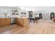 Open concept home interior featuring a combined kitchen, dining, and living room with hardwood flooring at 417 S Pontiac Way, Denver, CO 80210