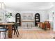 Spacious living room with hardwood floors, stylish seating, a modern painting, and built-in shelving units at 417 S Pontiac Way, Denver, CO 80210